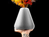 Rillan tapered flower vase with fine vertical ribs and floral stems