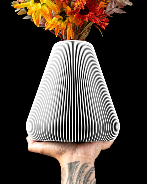 Rillan pear-shaped ribbed vase with broad lower body and narrow opening
