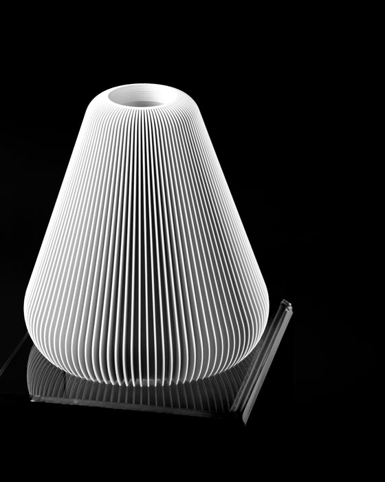 Angled view of Rillan vase showing tapered silhouette and fine fluting