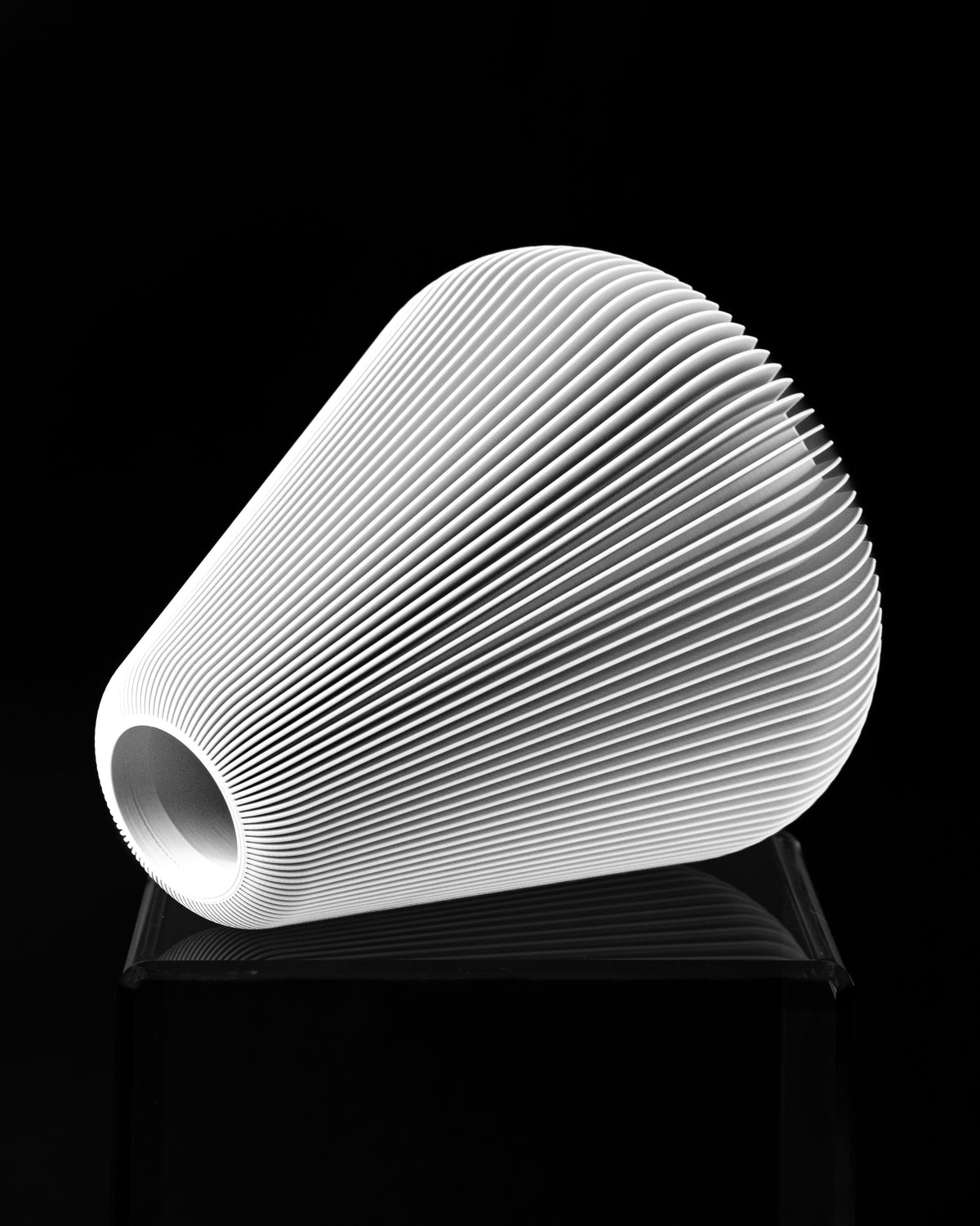 Side view of Rillan flower vase with small top opening and vertical ribs