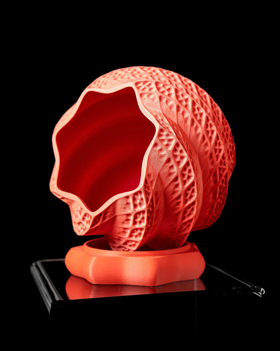 Modern 3D printed planter pot in bold coral red with detailed surface patterns, ideal for succulents or bonsai. This indoor planter is both functional and decorative, designed for creative home spaces. Whether as gifts for mom or standout pots and planters, this planter pot's unique structure makes it a stylish and sustainable home accessory.