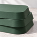 Close-up of the rounded corner, offset layers and fine printed texture of a forest green plant stand.