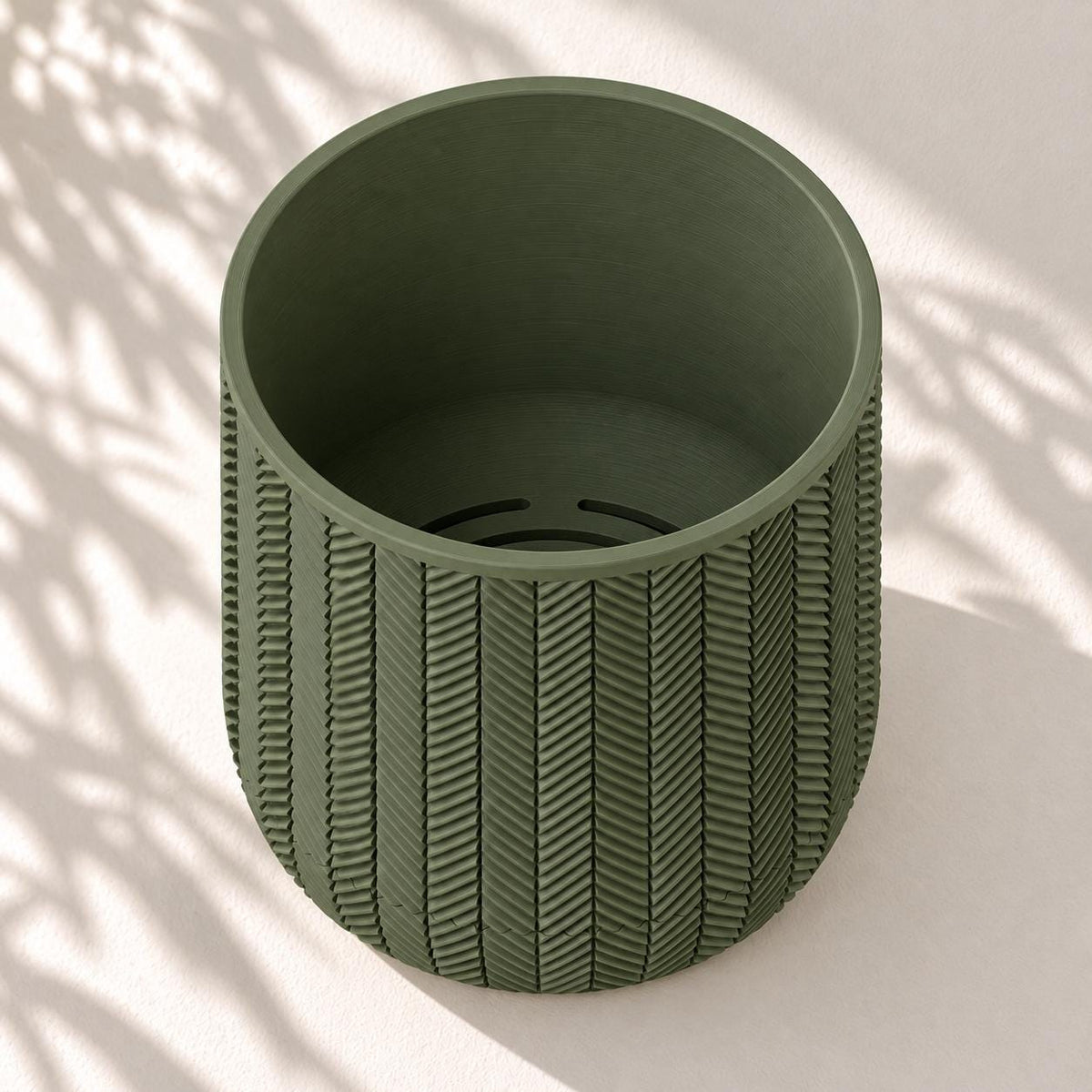 Empty Spigo herringbone wall planter viewed from above, showing the round opening and planting cavity.