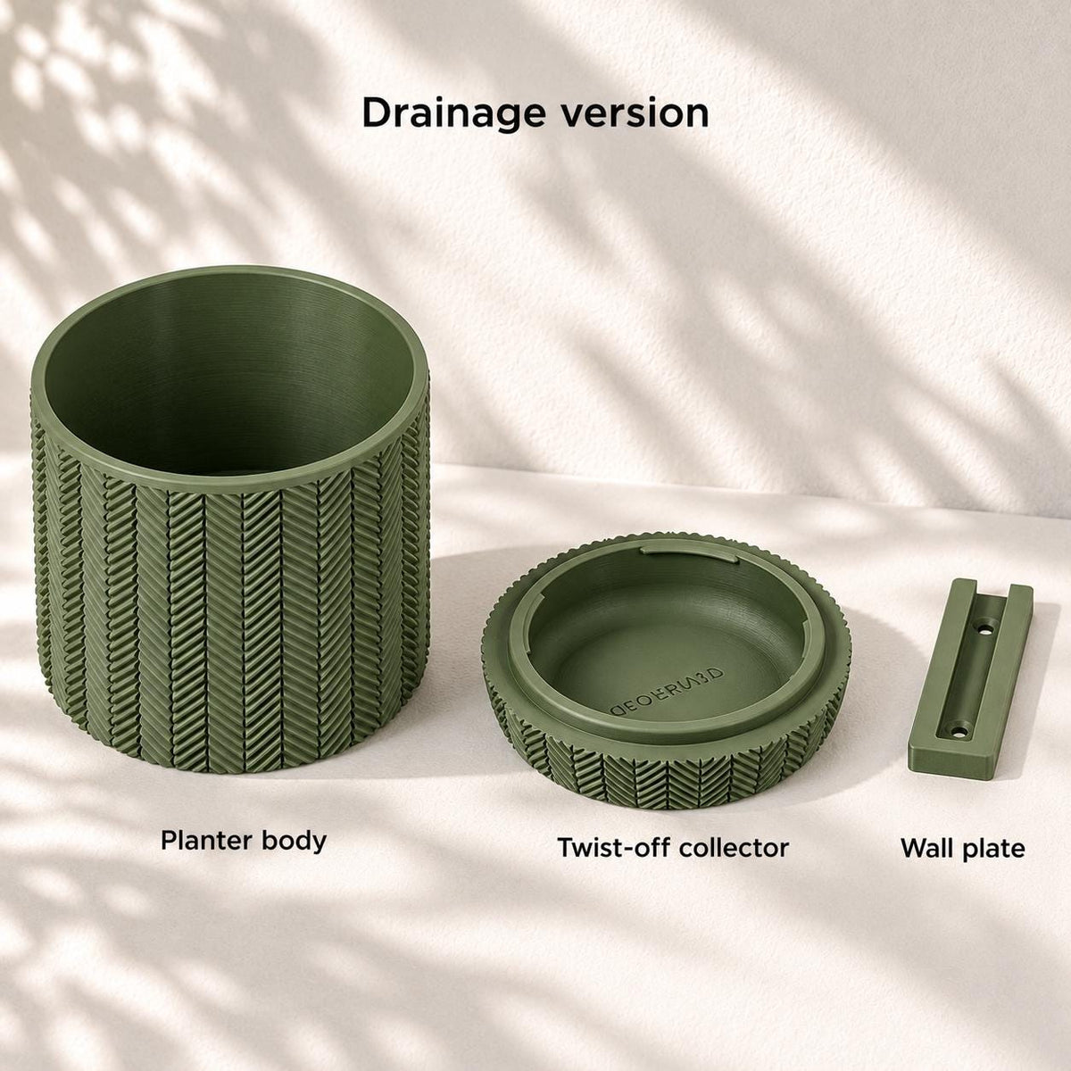 Spigo wall planter components: herringbone planter body, removable lower water collector and wall mounting plate.