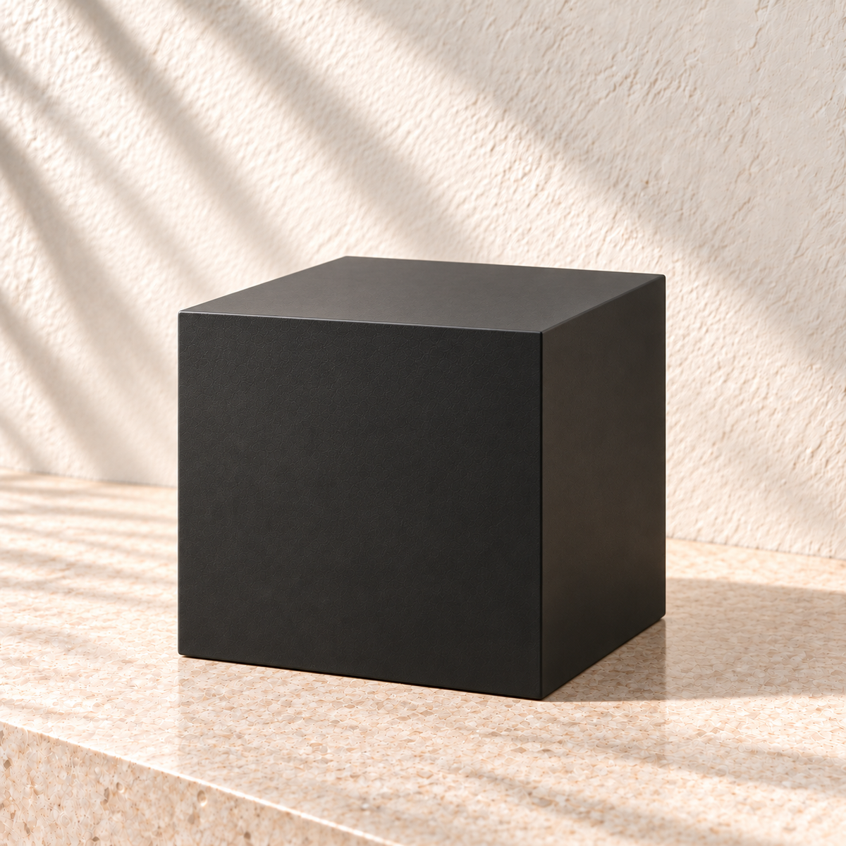Black square plant pedestal viewed at an angle, showing its flat square top and straight sides.