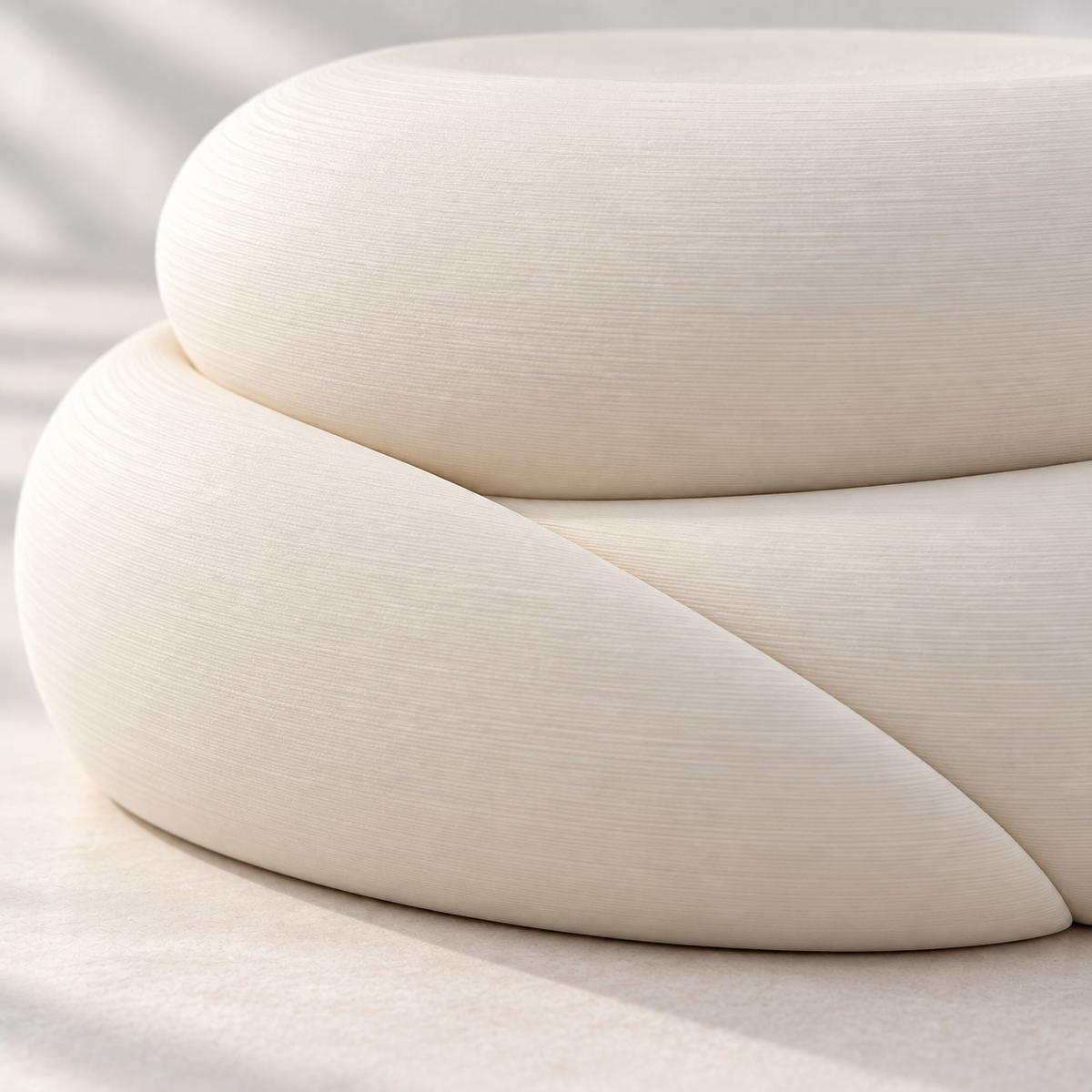 Close-up of the Cream White Talvo stand showing its curved pebble shape and diagonal division.