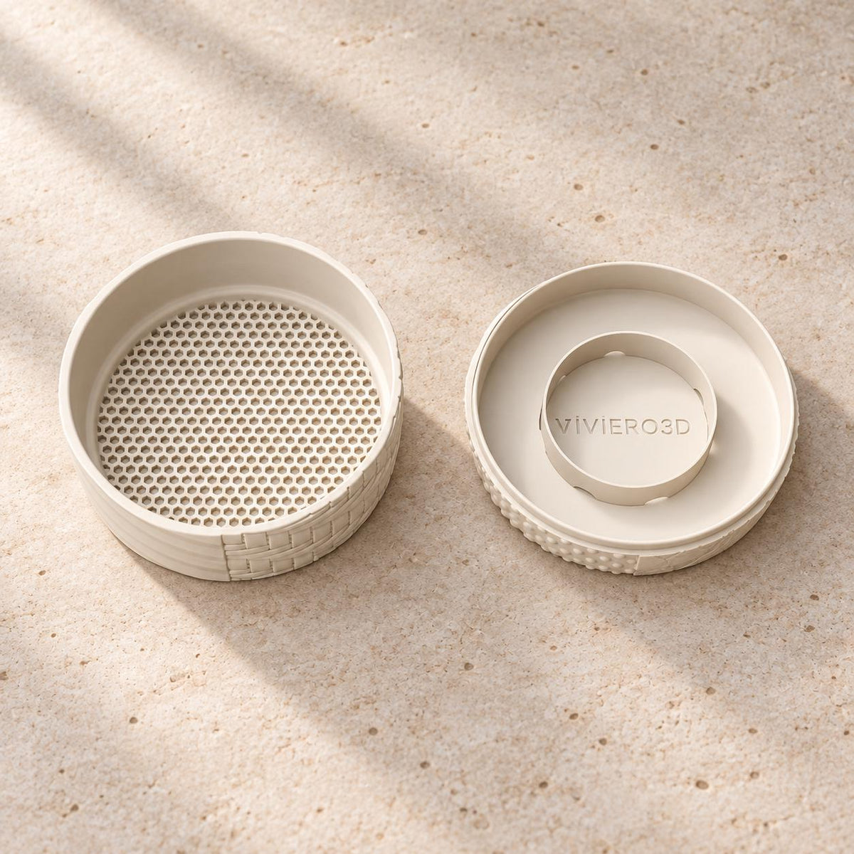 Detail view of the Tessaro round bonsai planter, a shallow cream plant pot with textured panels.