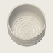 Top-view render inside the standard Tessaro pot showing smooth inner walls, curved drainage slots and a small center opening, without wick supports.