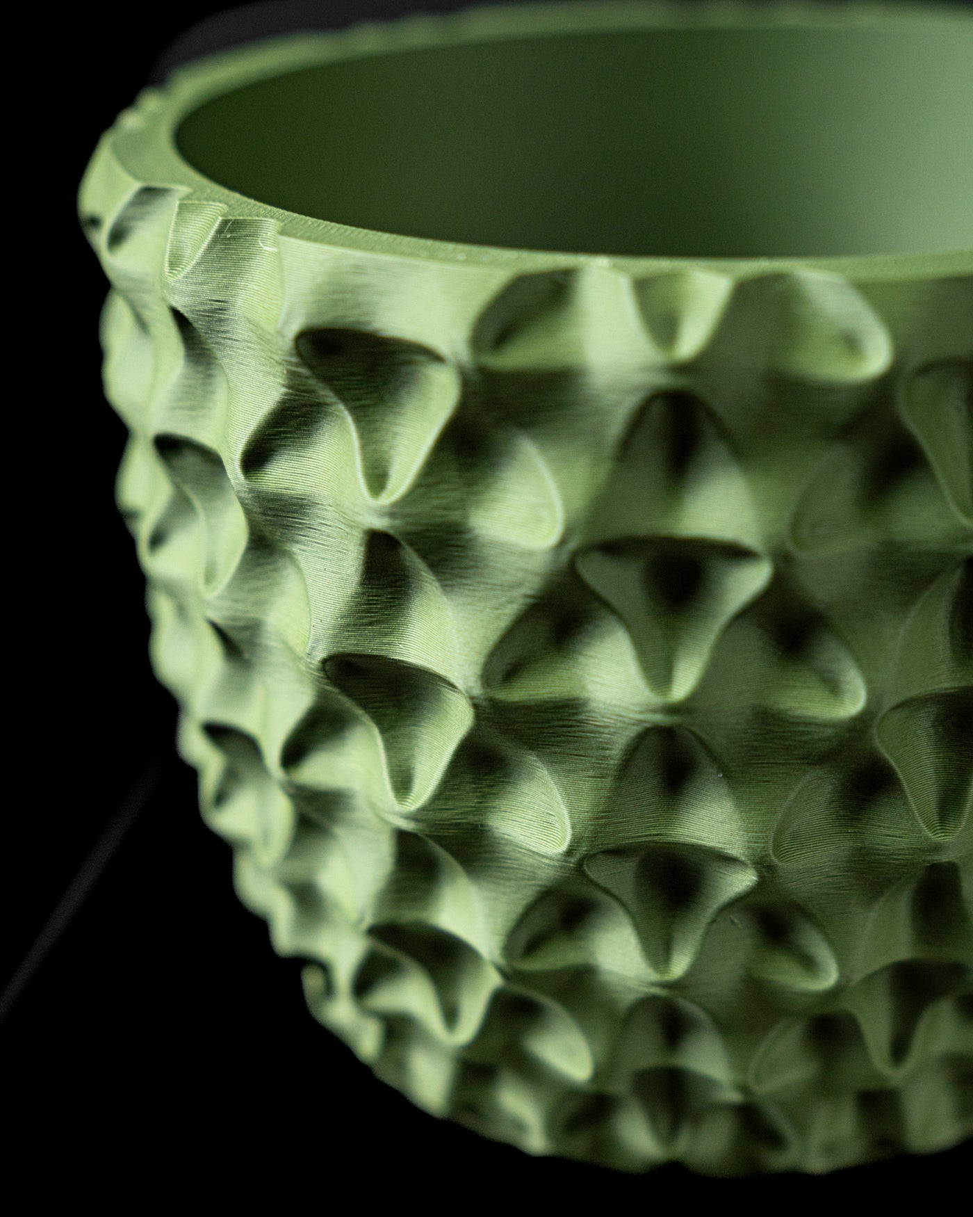 Close-up of TriWave planter deep geometric wave texture
