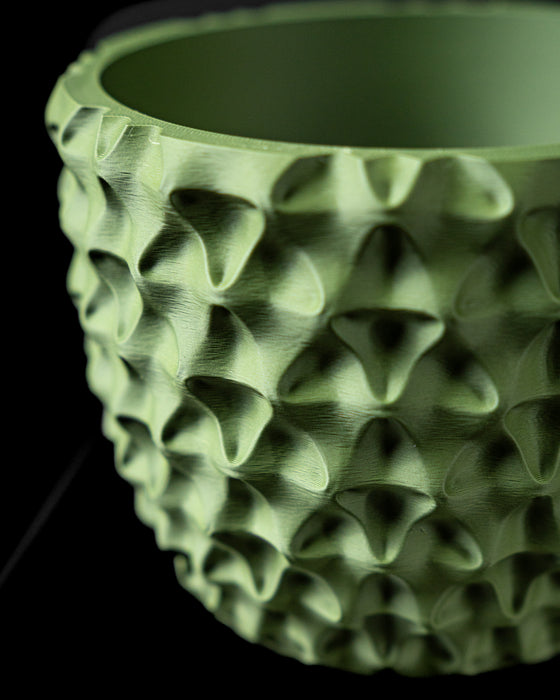 Close-up of TriWave planter deep geometric wave texture