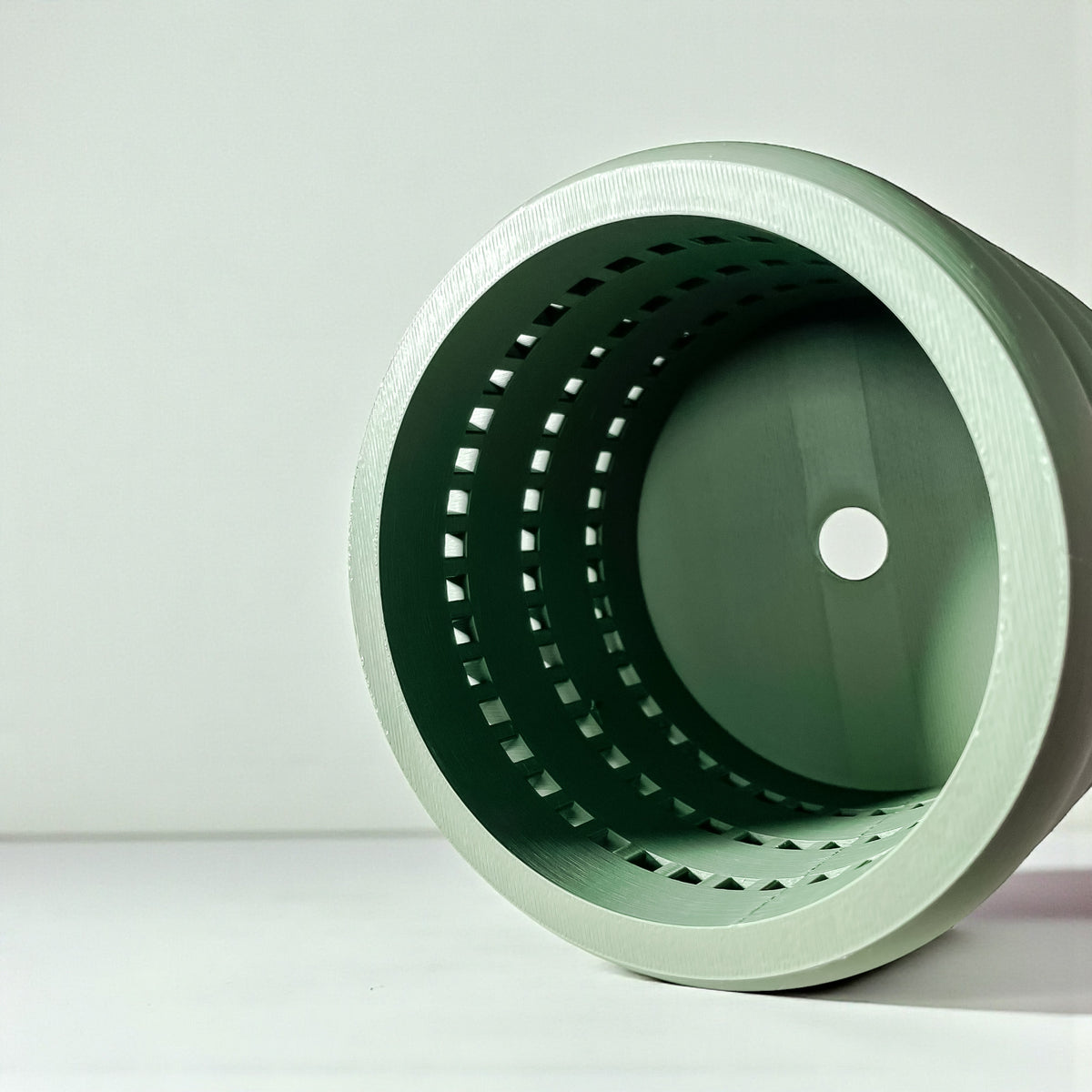 Ulra ventilated orchid pot with horizontal bands, top opening and drainage hole view