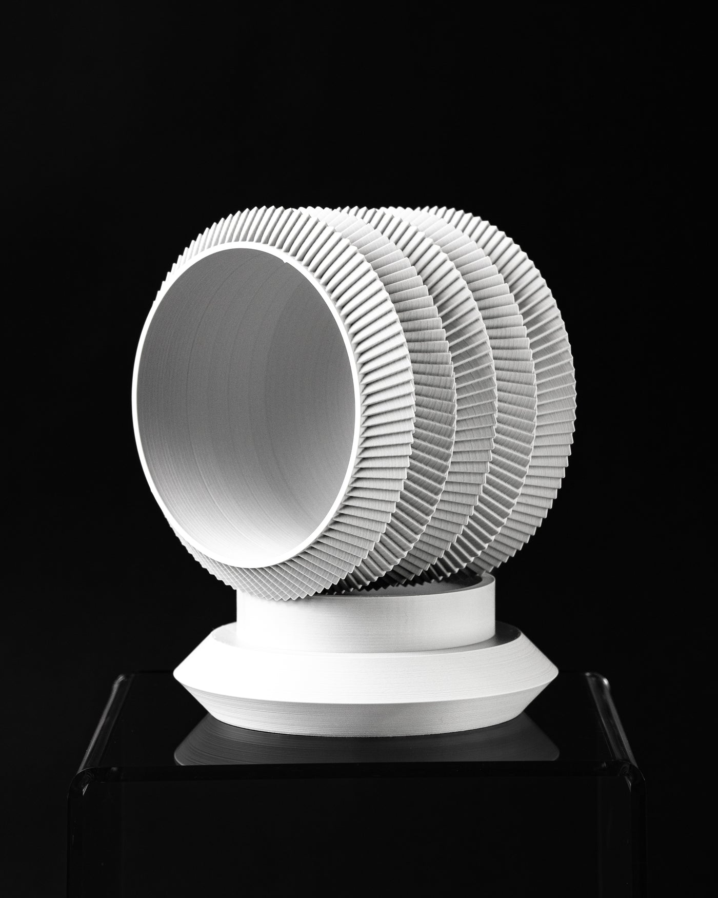 Varo round planter tilted view showing opening and layered ribbed profile