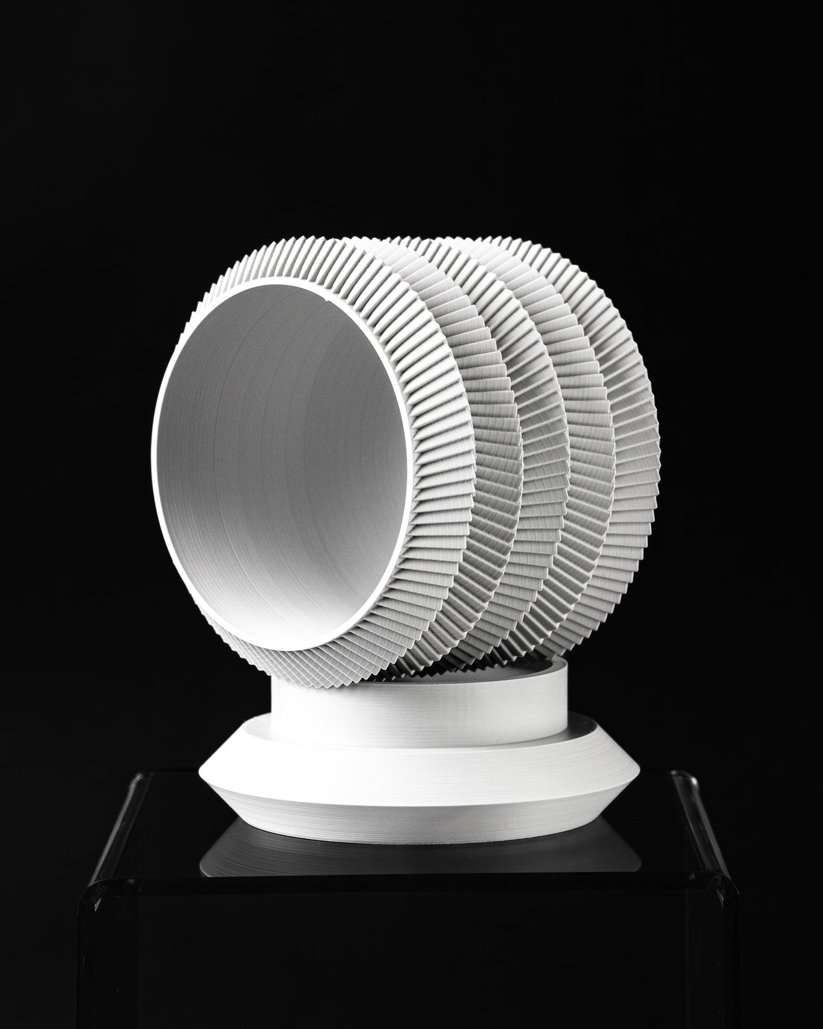 Varo round planter tilted view showing opening and layered ribbed profile