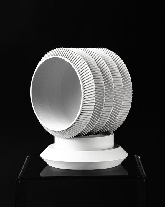 Varo round planter tilted view showing opening and layered ribbed profile