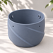Grey Blue hanging planter without drainage, with a seamless one-piece body, sculptural folds and reinforced cord openings.