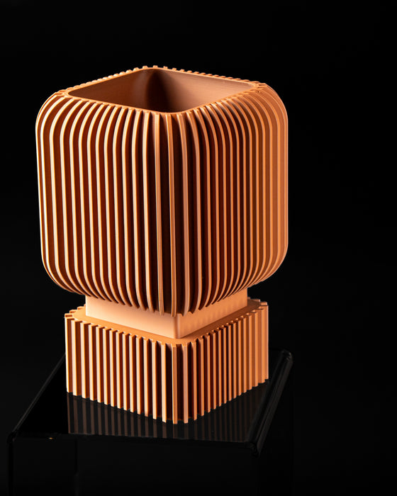 Angled view of Vexo square ribbed planter showing planting opening