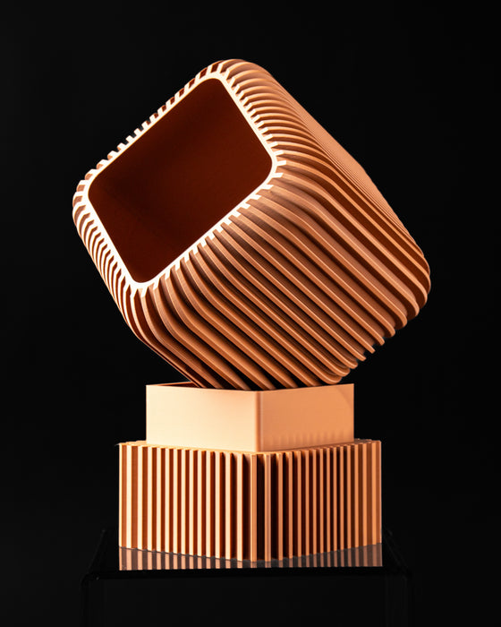 Vexo planter tilted above its square pedestal base