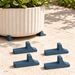 Four matching blue-grey Canto pot feet beside a cream planter raised on pot feet, showing the gap beneath its base.