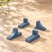 Four blue-grey ASA plant pot feet showing grooved support platforms and curved outer profiles.