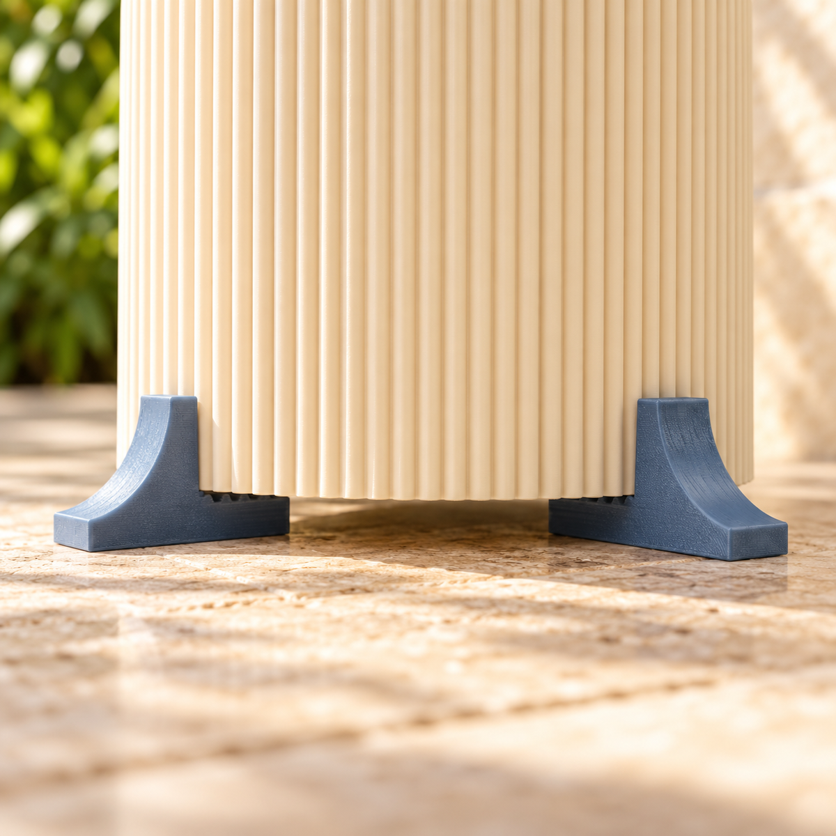 Close-up of blue-grey planter feet supporting a cream pot with a visible gap beneath the pot.