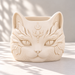 Front view of an empty cream white Sentinel cat planter with pointed ears and crescent moon relief