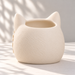 Rear view of a cream white Sentinel cat planter with pointed ears and a textured back