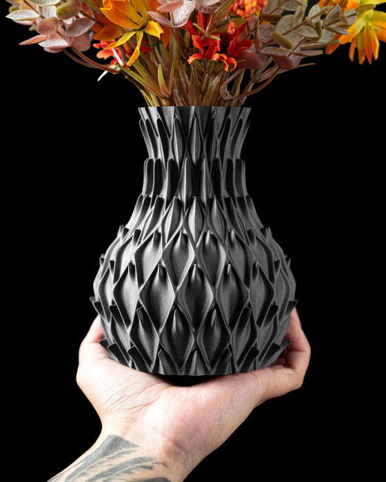 black vase with rounded petal-like indentations evenly distributed across the surface, modern vase with intricate relief pattern, miniature flower vase for dried flowers or ikebana, 3d printed vase with sculptural texture and personalized design, unique gift and home office decor, vases for flowers and unique home decor accent, aesthetic vase with a symmetrical silhouette and matte surface finish
