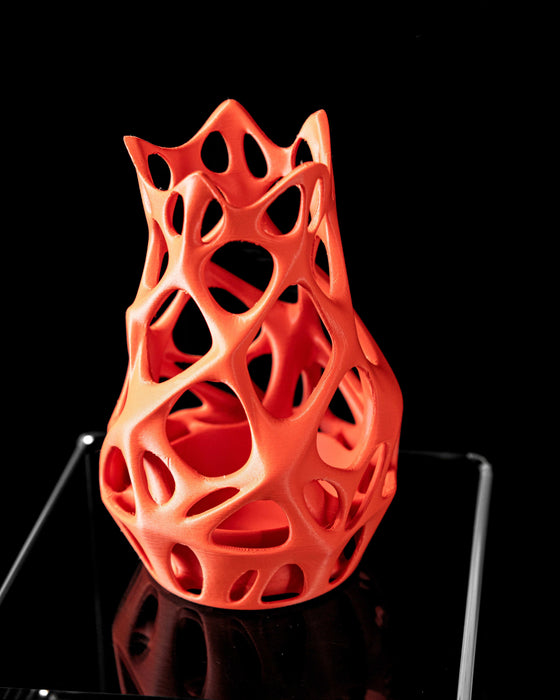 orange modern vase on display, composed of organic parametric lattice with multiple openings, flower vase for ikebana or dried botanicals, 3d printed vase with airy shape and intricate layered flow, unique decor accent for home office or living space, aesthetic vase with bright matte finish and coral-inspired contours