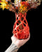 close-up of 3d printed orange vase with open mesh pattern and sculpted peaks, modern vase with coral-like architecture and perforated curves, aesthetic vase for dried flowers or decorative stems, vases for flowers with smooth parametric flow and bold minimalism, personalized vase with expressive organic geometry