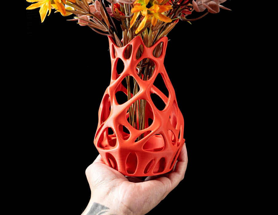 orange vase with dynamic open design, viewed from side showing soft shadows and inner volume, modern flower vase with parametric pattern and 3d printed continuity, unique sculptural decor for home office or special gifting, personalized vase for flowers or interior styling with artistic precision
