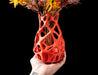 orange vase with dynamic open design, viewed from side showing soft shadows and inner volume, modern flower vase with parametric pattern and 3d printed continuity, unique sculptural decor for home office or special gifting, personalized vase for flowers or interior styling with artistic precision
