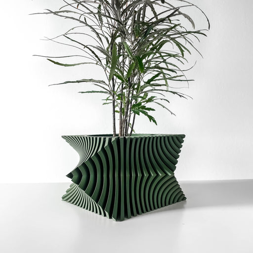 Green 3D printed planter pot with wide fluted base, narrow top opening, and vertical sculptural fins forming dynamic silhouette