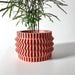 Geometric planter with stacked ripple pattern and stable rounded base, modern 3D printed pot featuring symmetrical wave ridges