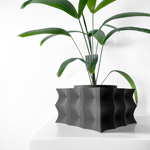 Black 3D printed planter pot with bold wavy surface, rectangular silhouette and textured lines running horizontally