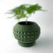 Modern 3D printed planter pot with geometric pyramid pattern, featuring a smooth rounded upper lip, thick-walled body, and elevated circular base for stability, suitable for small indoor plants, color customizable, PLA material