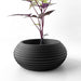Minimalist planter featuring wide base and curved sides with 3D printed lines