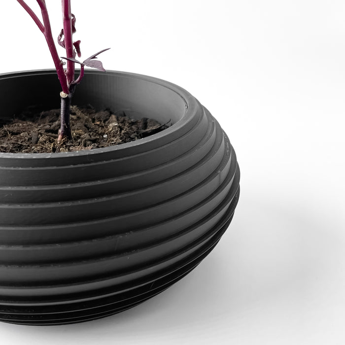 Side view of ribbed decorative planter, showcasing round opening and smooth rim