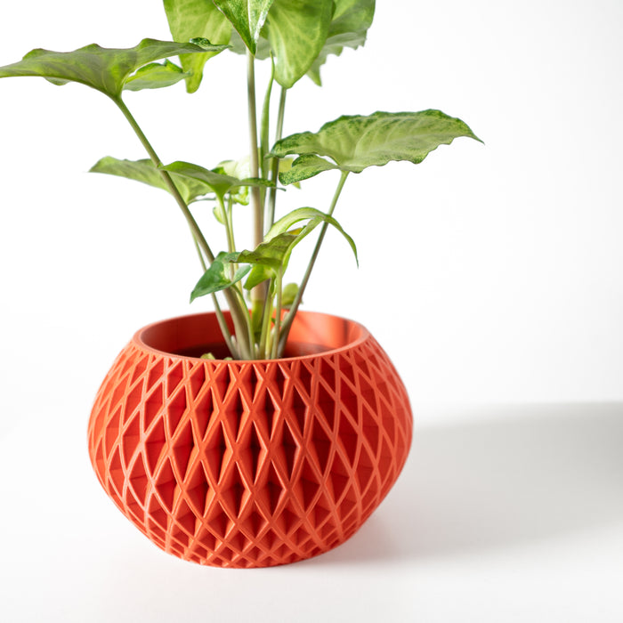 Compact tabletop plant pot with sculptural faceted walls and smooth symmetrical curves
