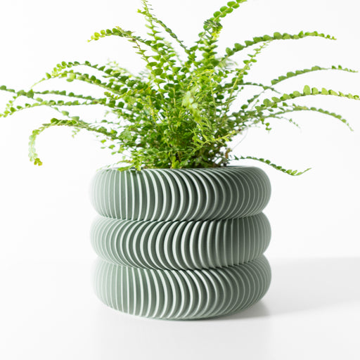 3D printed geometric flower pot with stacked wave-like rings and bold sculptural form, modern planter pot for houseplants or ferns