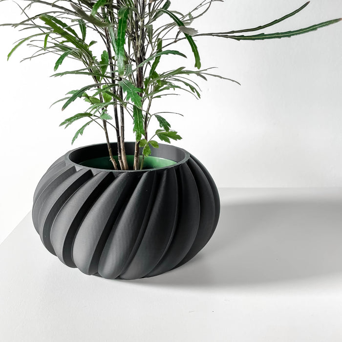 Bold black flower pot with vertical ripple design, 3D printed for futuristic decor and plant lovers