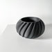 Contemporary ribbed pot with curved petal-like folds, ideal for modern home decor and sculptural plant displays