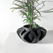 Futuristic 3D printed planter with ribbon-like sculptural design and open structure, bold decorative pot for houseplants and modern interiors