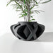 Unique sculptural plant pot with asymmetrical silhouette and layered structure, ideal for succulent or fern display