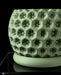 Textured green pot with circular protrusions, perfect for houseplants and home decor