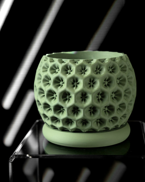 Textured green pot with circular protrusions, perfect for houseplants and home decor
