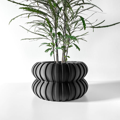 Black 3D printed planter pot with stacked oval ridges creating a layered ripple effect, precision-made with matte surface finish, crafted from eco-friendly PLA.