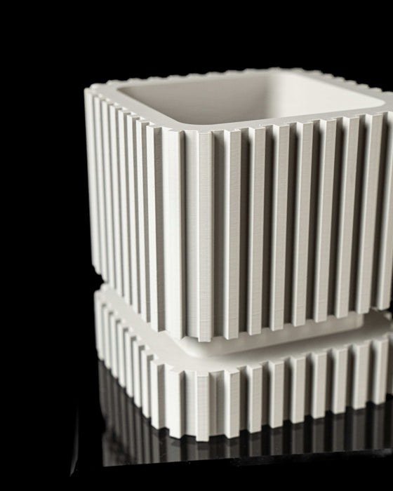 minimalist planter pot with deep fluting and geometric lines, functional and decorative flower pots for college gifts