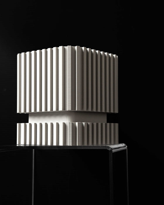 sculptural flower pots with vertical cutouts and layered base, shown as unique planter for new home gift ideas