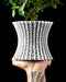 Vora openwork lattice planter with plant, handheld front view