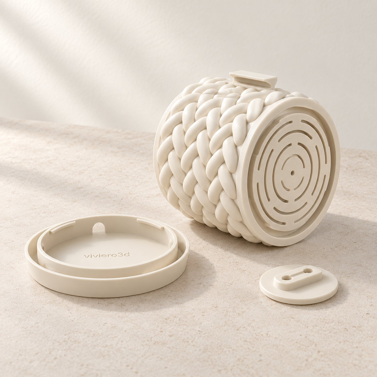 Braido wall planter parts showing bottom drainage slots, a detached round base and a small wall bracket.
